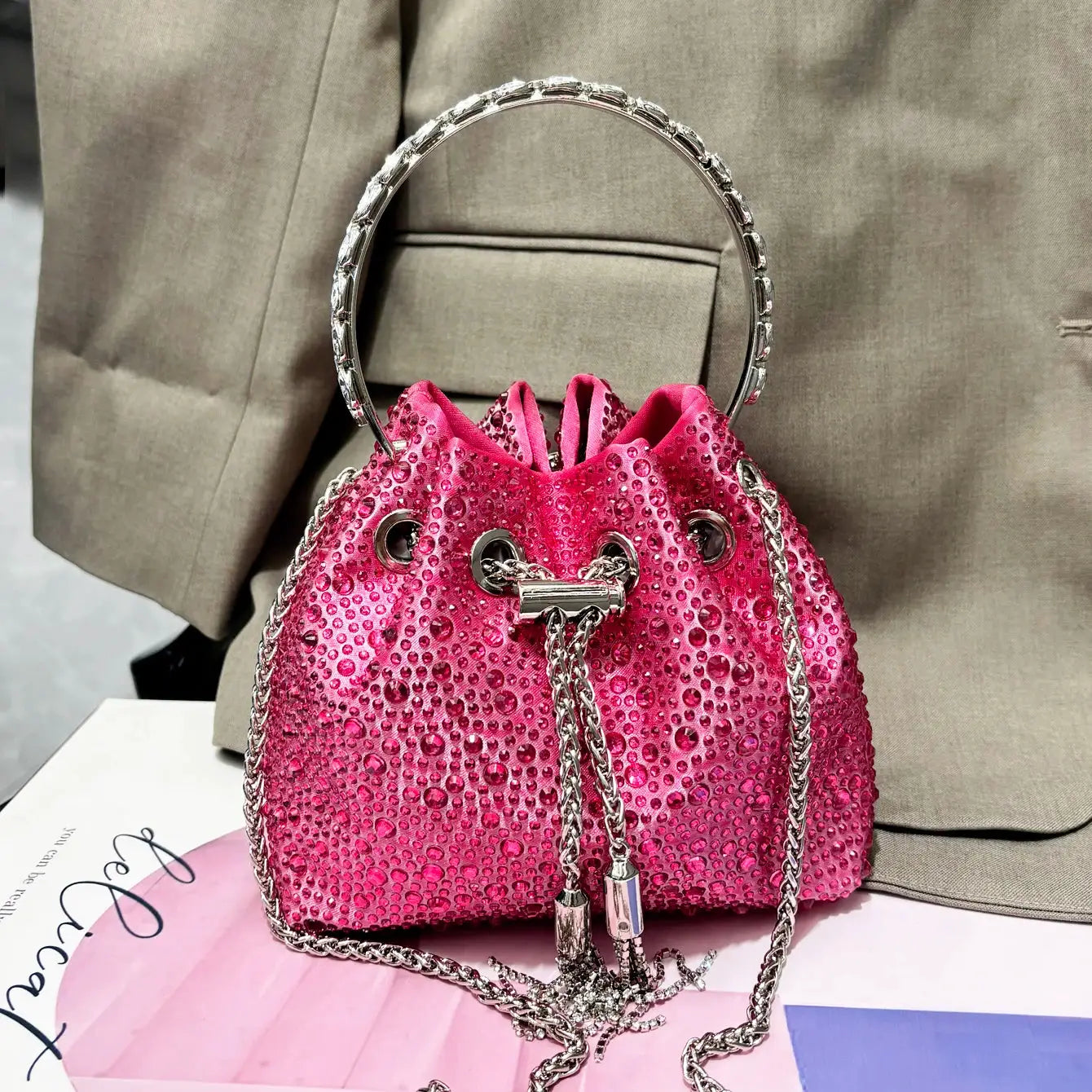 Evening clutch bag by Simples Market; pink rhinestone design with silver ring handle and chain