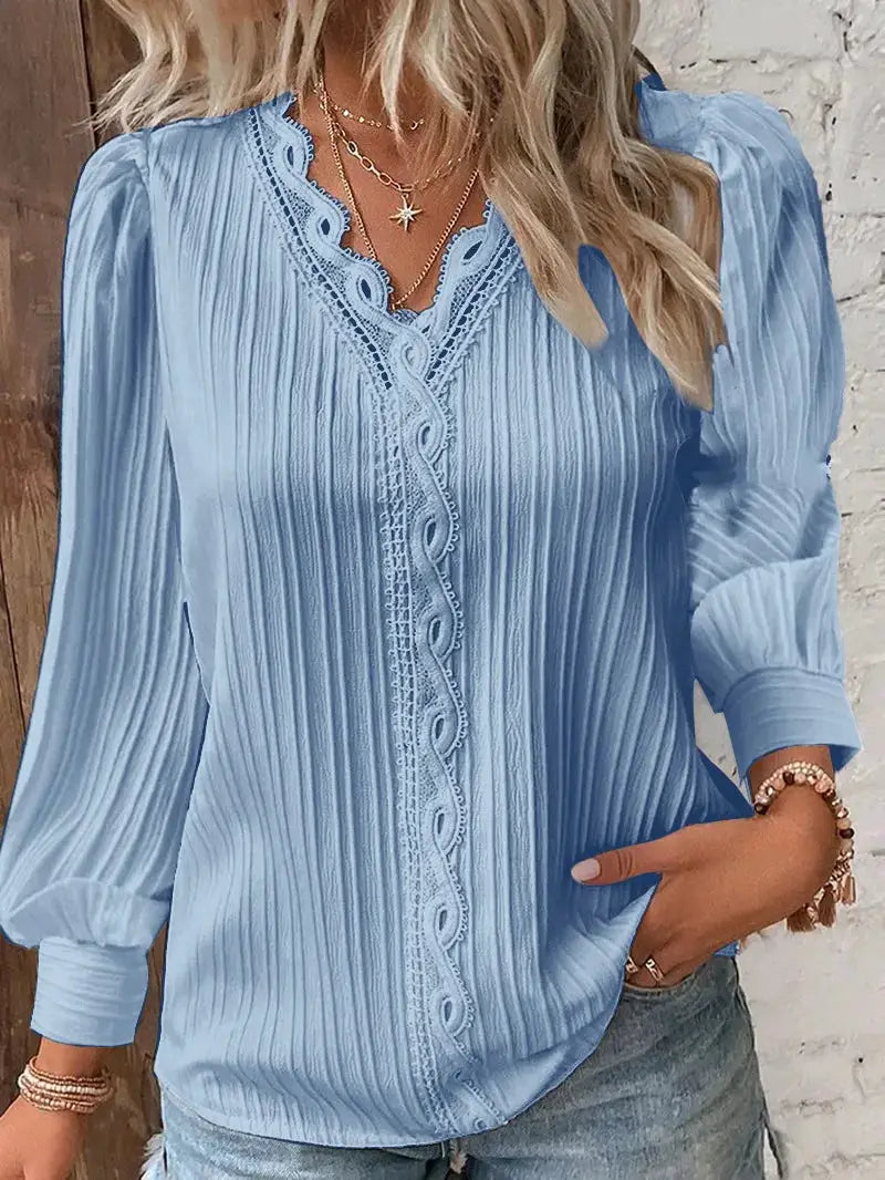 Blue women's blouse with V-neck, lace-trim placket, and vertical pleated texture, long sleeves