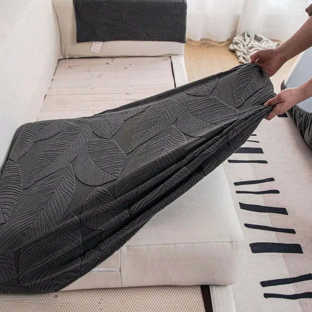 Sofa seat cushion cover in dark grey jacquard fabric with leaf pattern; stretchy waterproof cover.