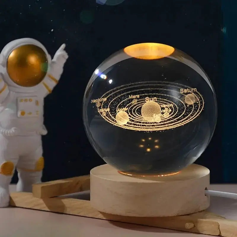 3D Crystal Ball Night Light by Simples Market, glass globe with laser-engraved solar system on a wooden base