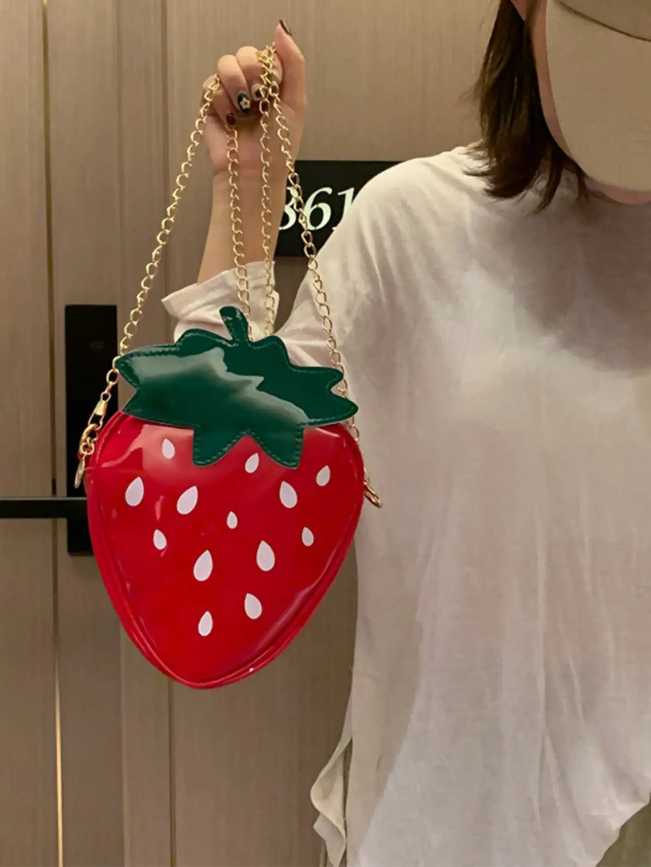 Strawberry-shaped crossbody bag, red with white seeds, green leaf, gold chain strap by Simples Market