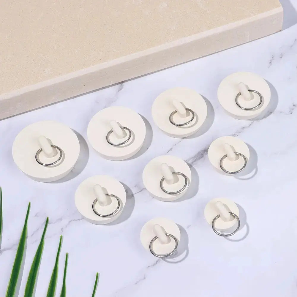 White rubber sink drain stoppers with metal rings, set of 9