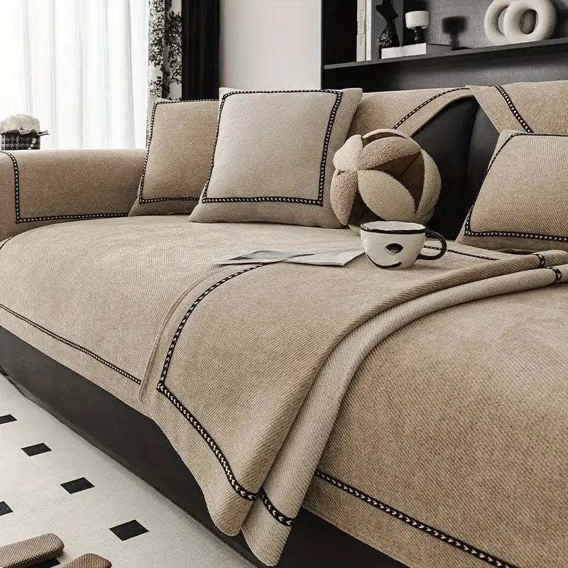 Vintage-style sofa slipcover, beige chenille fabric.
