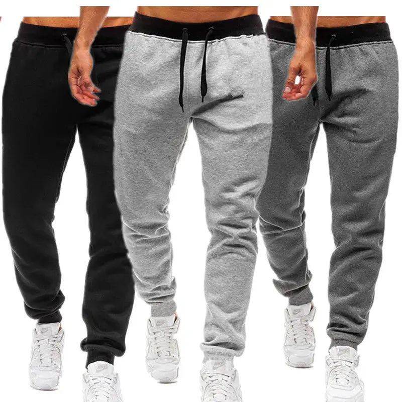 Men's loose straight-leg jogger pants set in three colors: black, light grey, dark grey with drawstring waist and cuffed ankles.