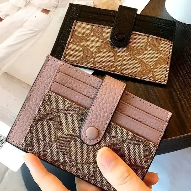 Simples Market card holder wallets (2): pink pebbled wallet with snap strap and brown monogram envelope wallet.