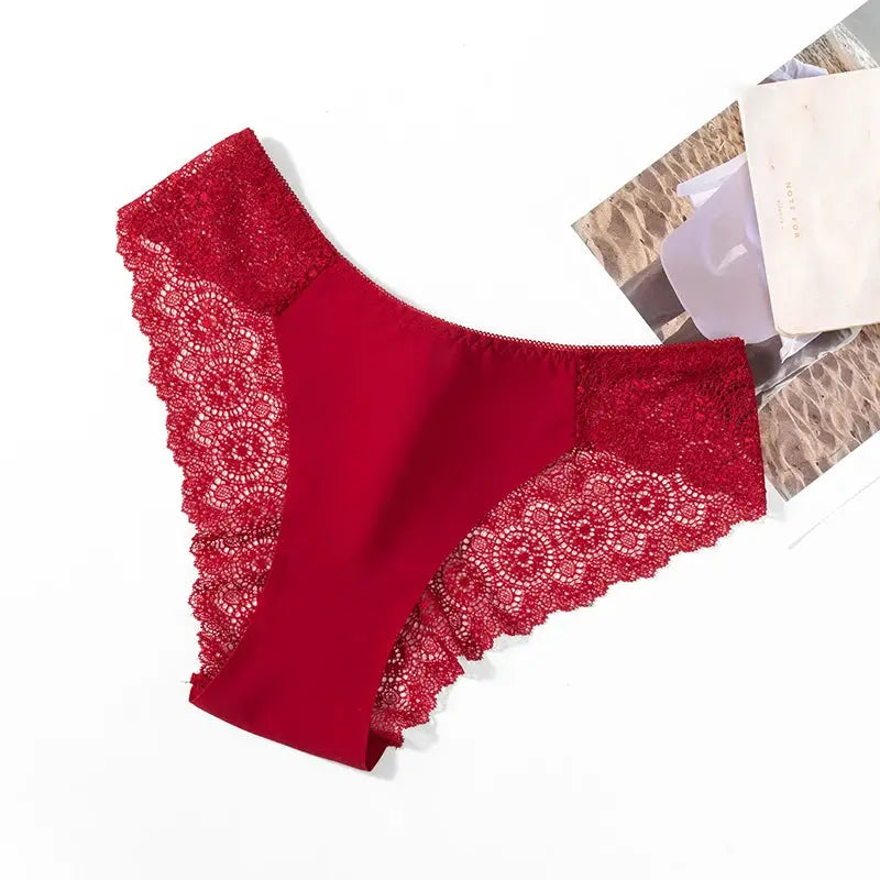 Women's red satin panties with delicate lace trim along the sides
