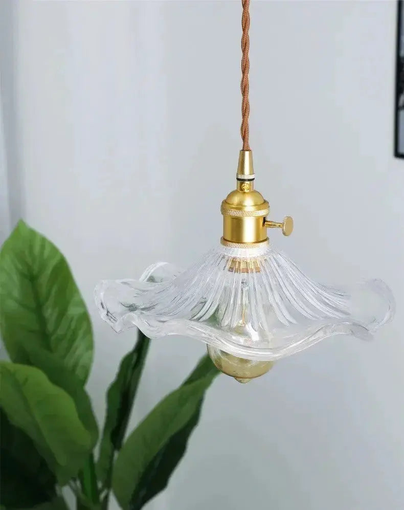 Nordic minimalist LED pendant light by Simples Market with brass hardware and clear wavy glass shade