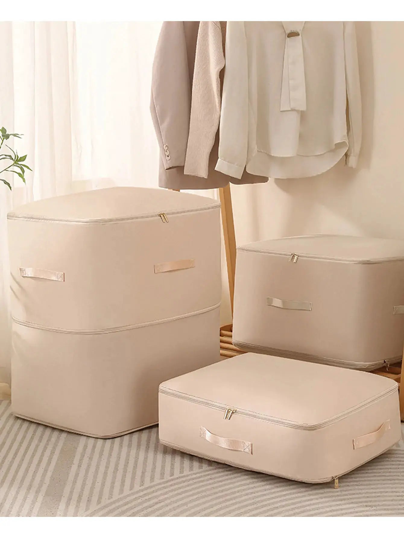Beige fabric packing cubes set; three pieces, large-capacity, dustproof, foldable closet storage.