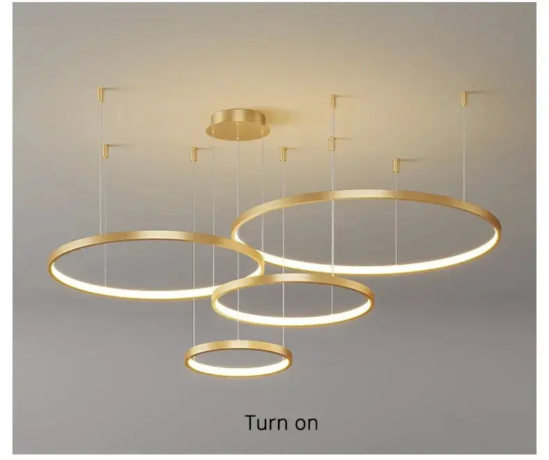 Pendant LED chandelier with four overlapping gold circular rings for modern living room decor