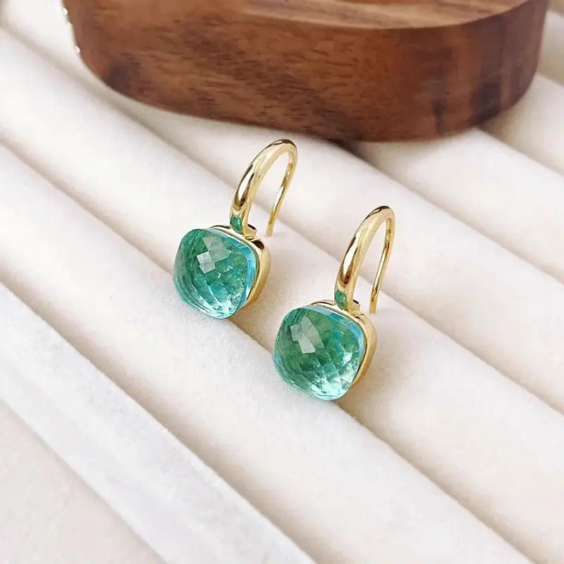 Drop earrings in gold-tone with teal 10mm cushion-cut crystals by Simples Market