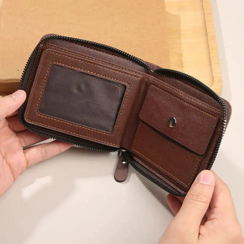 Men's brown leather zip-around wallet with clear ID window, coin pocket, and multiple card slots.