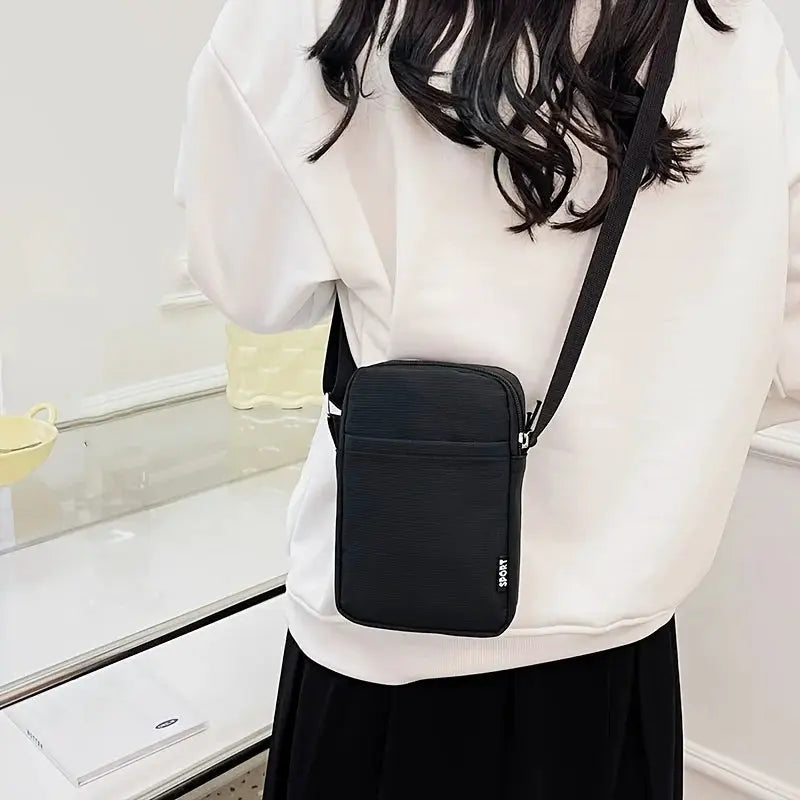 Black vertical shoulder messenger bag with compact crossbody design for phone and cards; SPORT logo visible