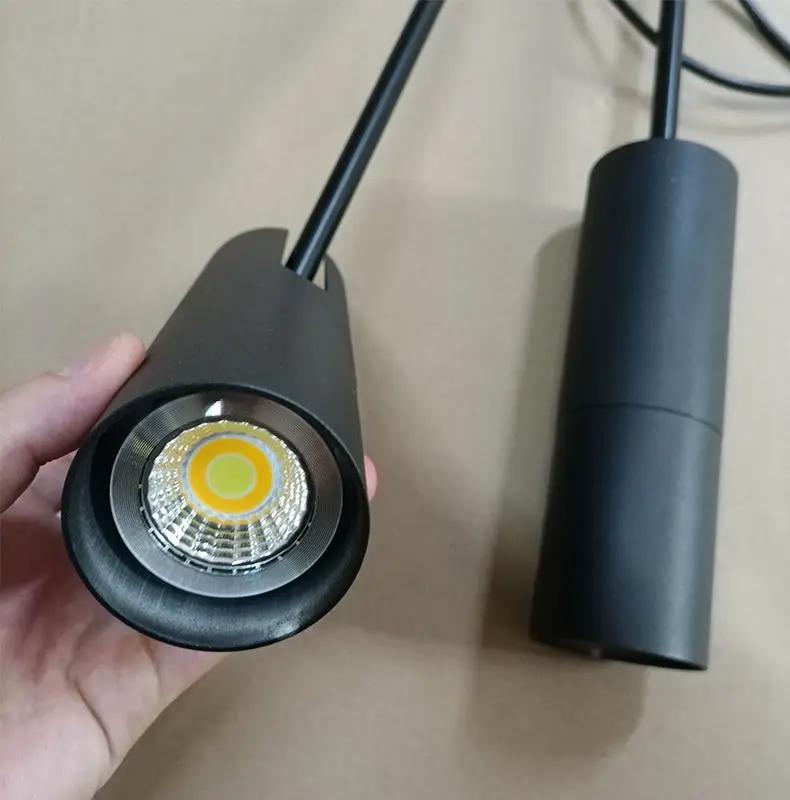 Minimalist LED hanging pendant light by Simples Market in black with cylindrical housing