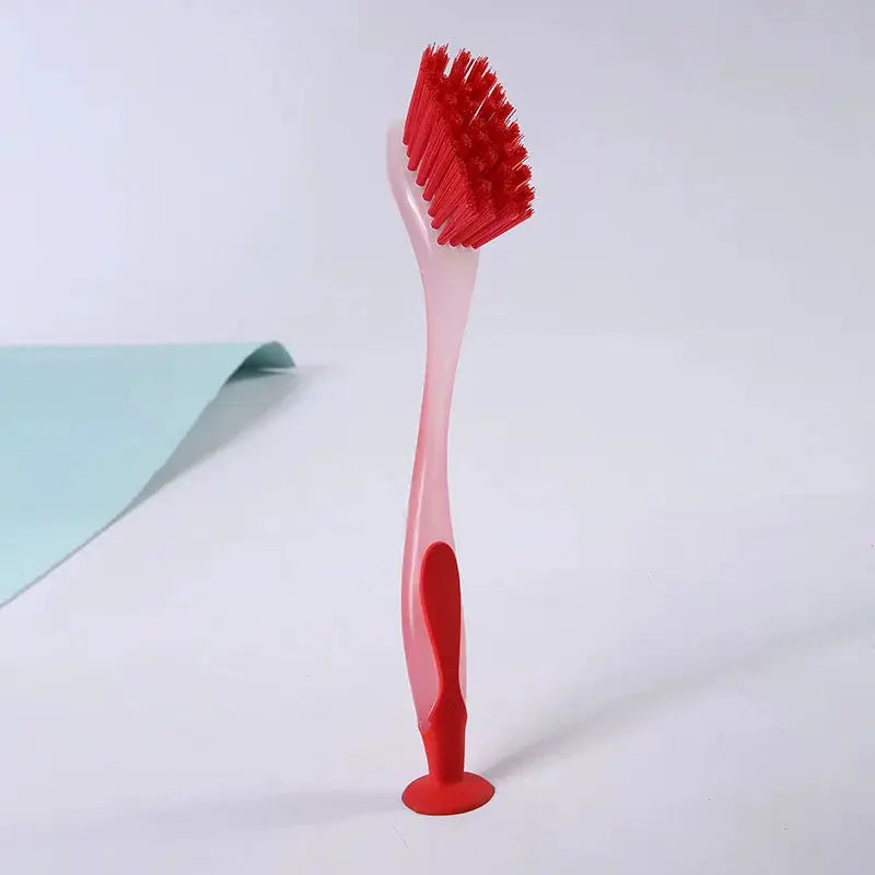 Simples Market pot cleaning brush with long pink handle and red bristles, suction cup base.