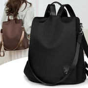 Women’s anti-theft backpack in black with adjustable shoulder strap; large-capacity travel bag (two bags shown).