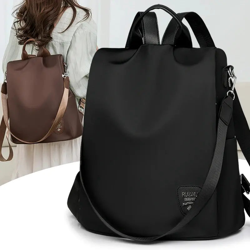 Women’s anti-theft backpack in black with adjustable shoulder strap; large-capacity travel bag (two bags shown).
