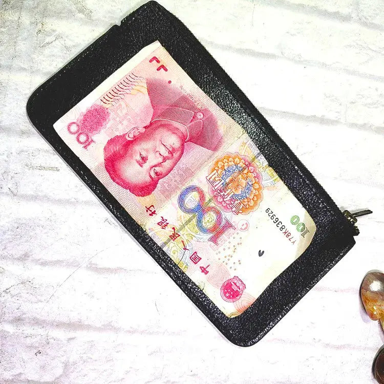 Mini zipper waist bag in black leather with a clear ID/card slot; contains a 100 yuan banknote.