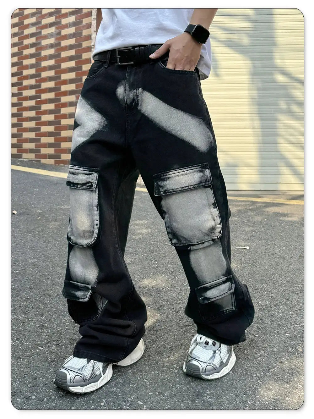 Men's black cargo jeans with multiple pockets and distressed gray splash patches, straight leg workwear style