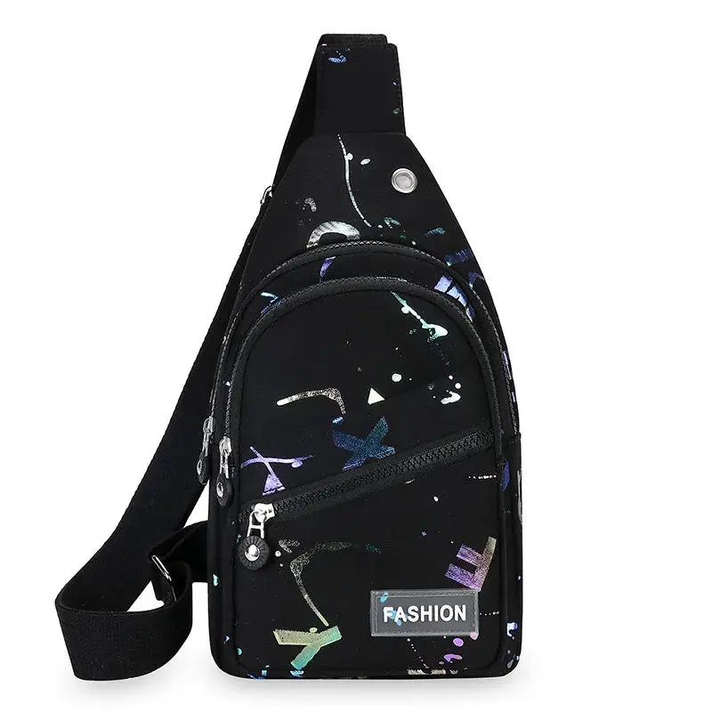 Chest bag crossbody sling backpack in black with multicolor paint-splatter print for women, featuring a front zip pocket.