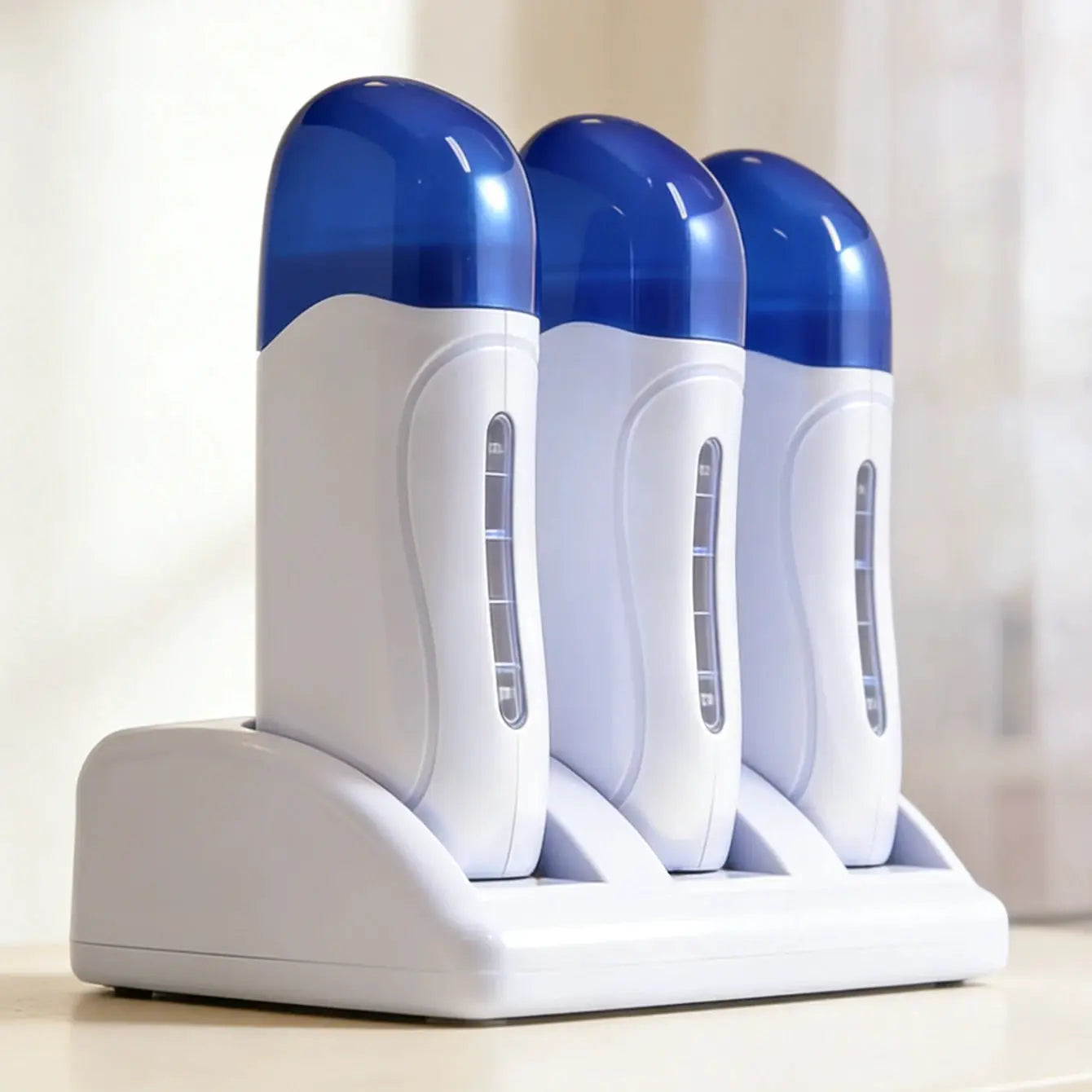 Three white roll-on wax heaters with blue caps in a white stand.