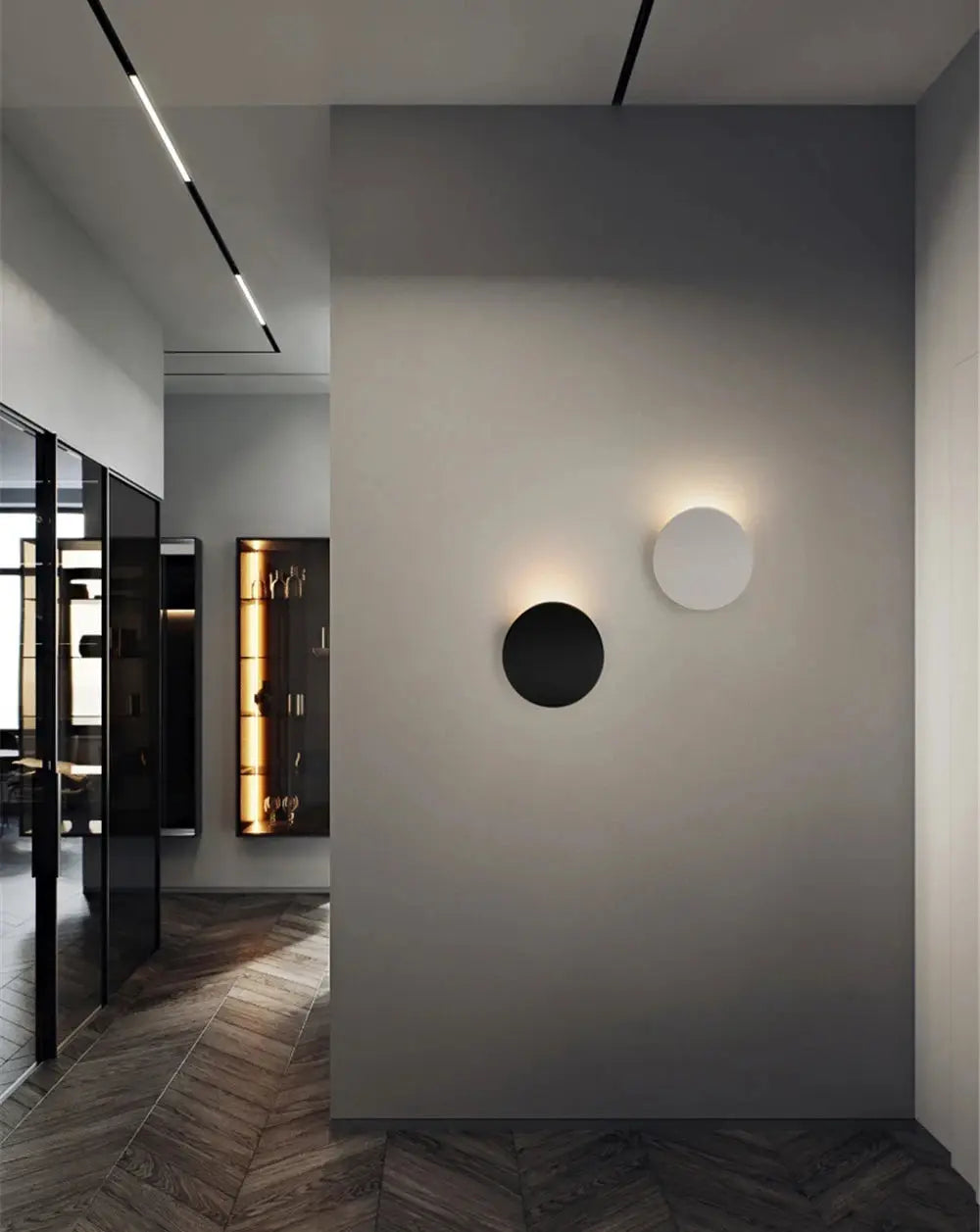 LED indoor wall lamps; two circular black and white wall-mounted sconces on a gray wall, modern lighting.