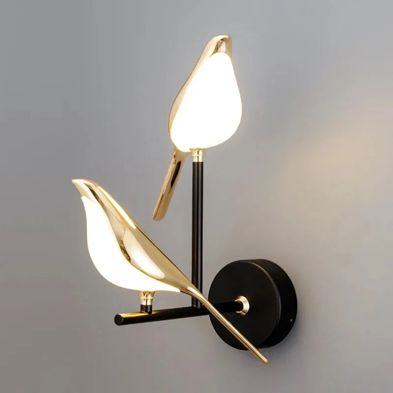 Modern LED wall lamp with two gold magpie bird accents on a black mounting plate by Simples Market