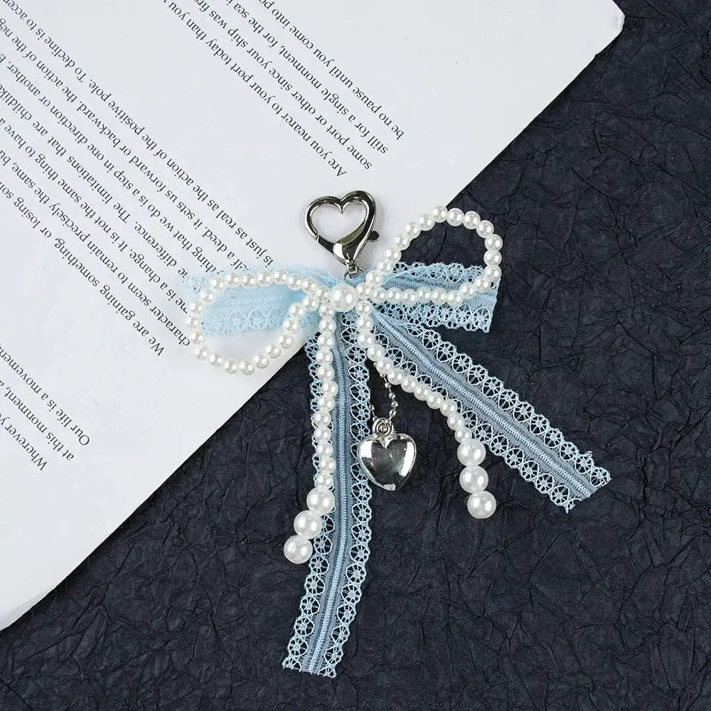 Keychain with imitation pearl beads, blue lace bowknot, and heart charm pendant for handbags