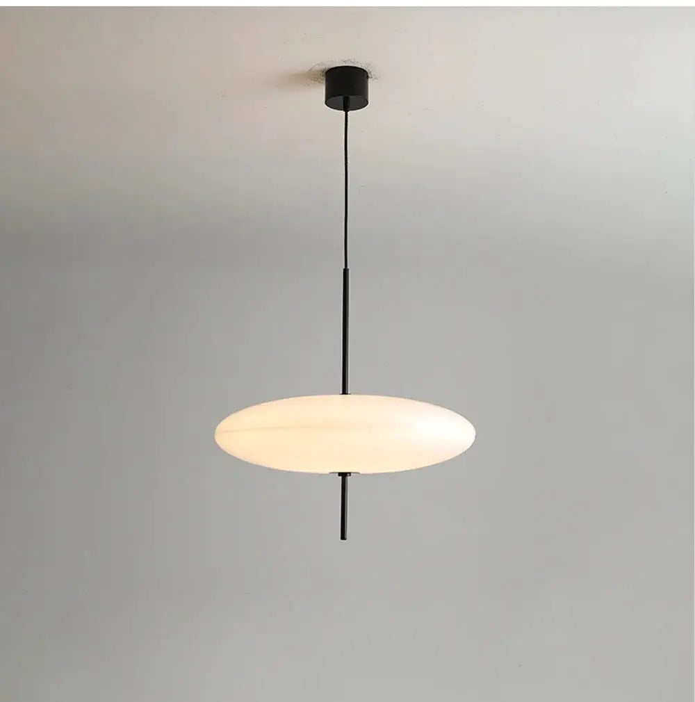 Nordic LED pendant light by Simples Market with a white flying saucer shade on a black cord
