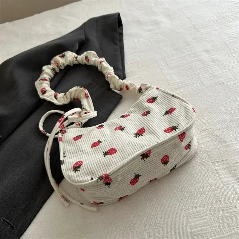 Corduroy underarm bag with strawberry print, white mini tote featuring half‑moon design by Simples Market
