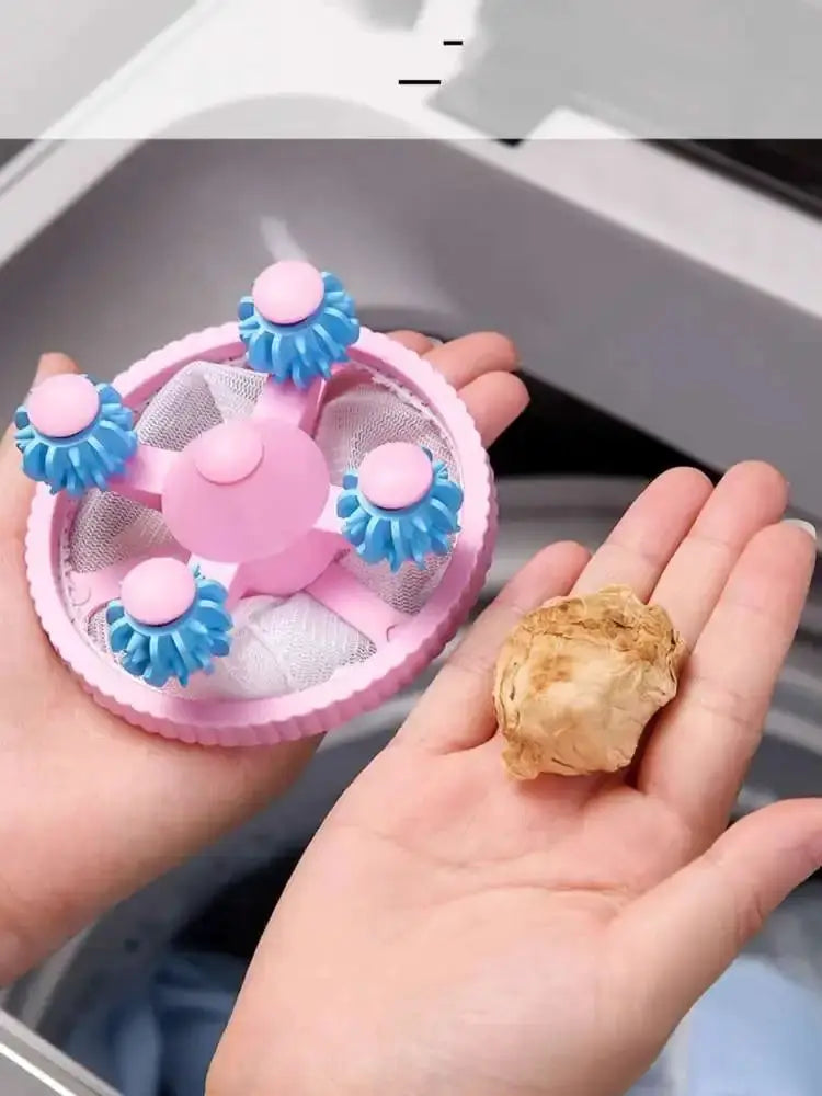 Pink reusable washing machine lint catcher ball with blue brush rollers and mesh interior.