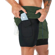Men's fitness training shorts, 2-in-1 quick-dry gym shorts, green/black with side pocket holding a phone