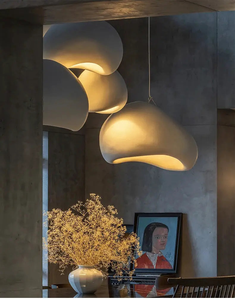 Nordic Wabi Sabi pendant lights; white sculptural LED ceiling chandeliers with warm ambient glow above dining area.