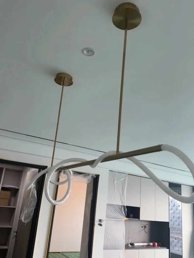 Pendant lights with brass finish and white looping cords, two Nordic dining room chandeliers