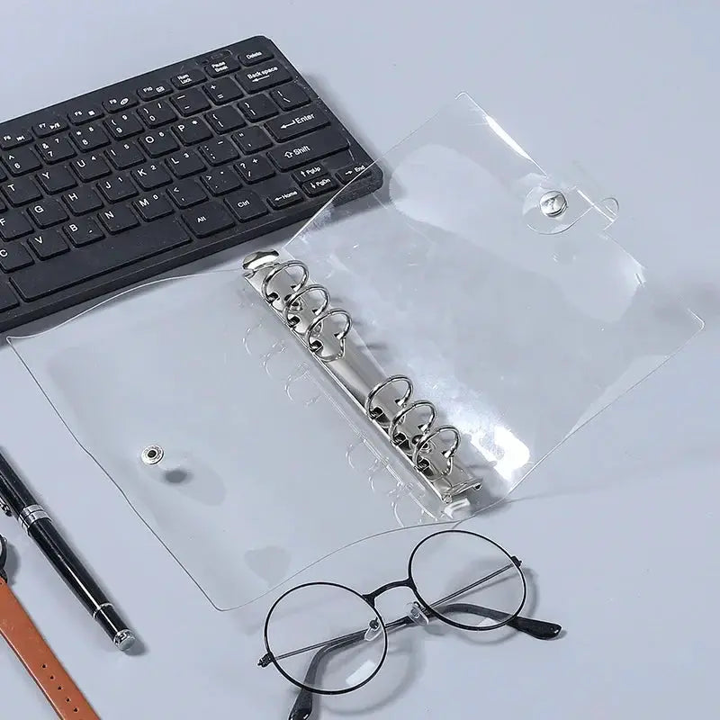 Transparent PVC 6-ring binder cover with snap button closure for ring-bound planner pages