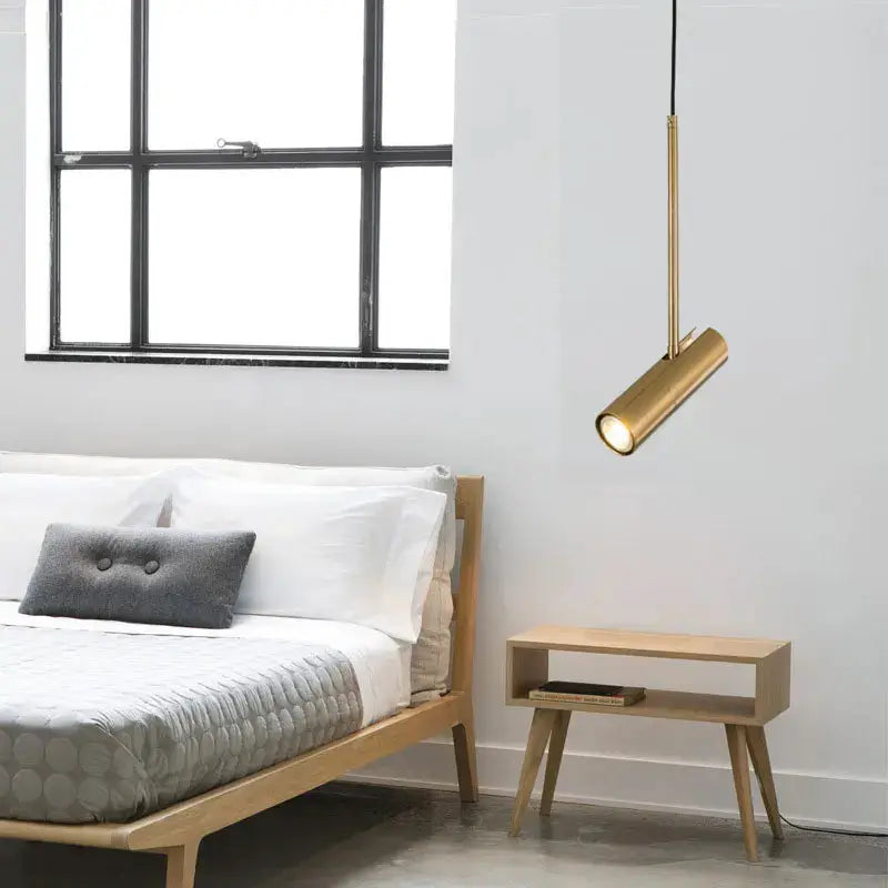 Minimalist LED hanging pendant light in gold brass finish by Simples Market