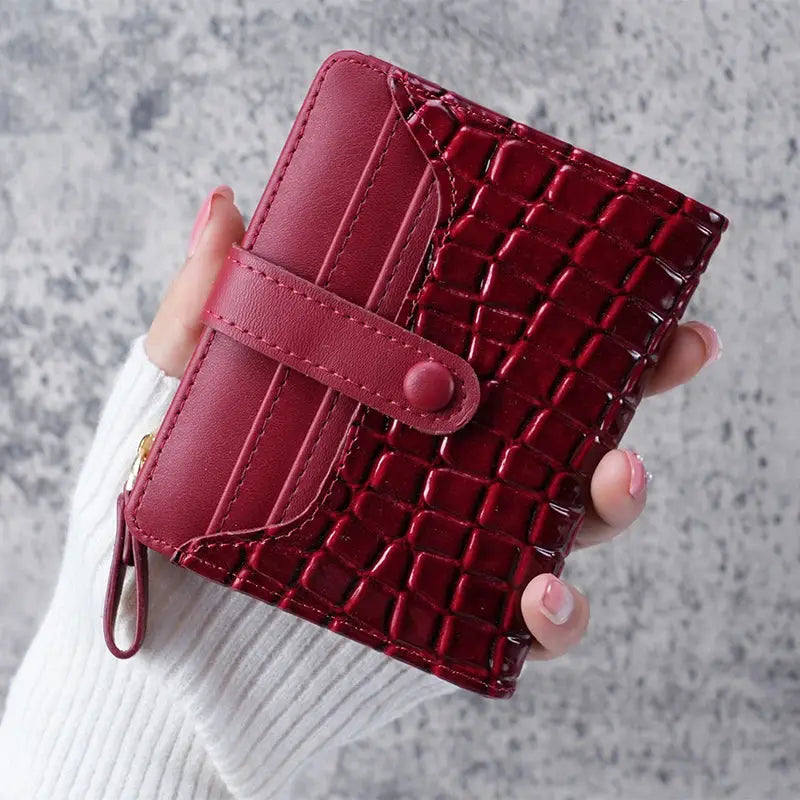 Simples Market mini crocodile-print clutch wallet in burgundy with card slots and wrist strap