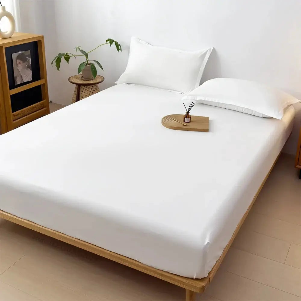 Simples Market white waterproof mattress cover fitted sheet on a full-size wooden bed with two white pillows