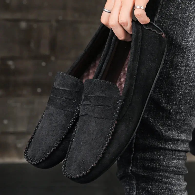 Pair of black suede men's loafers with burgundy lining, slip-on driving shoes with moccasin stitching