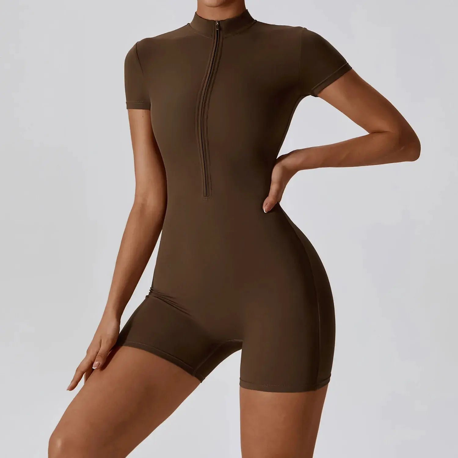 Women's brown zip-front yoga jumpsuit; short sleeves, form-fitting athletic romper.