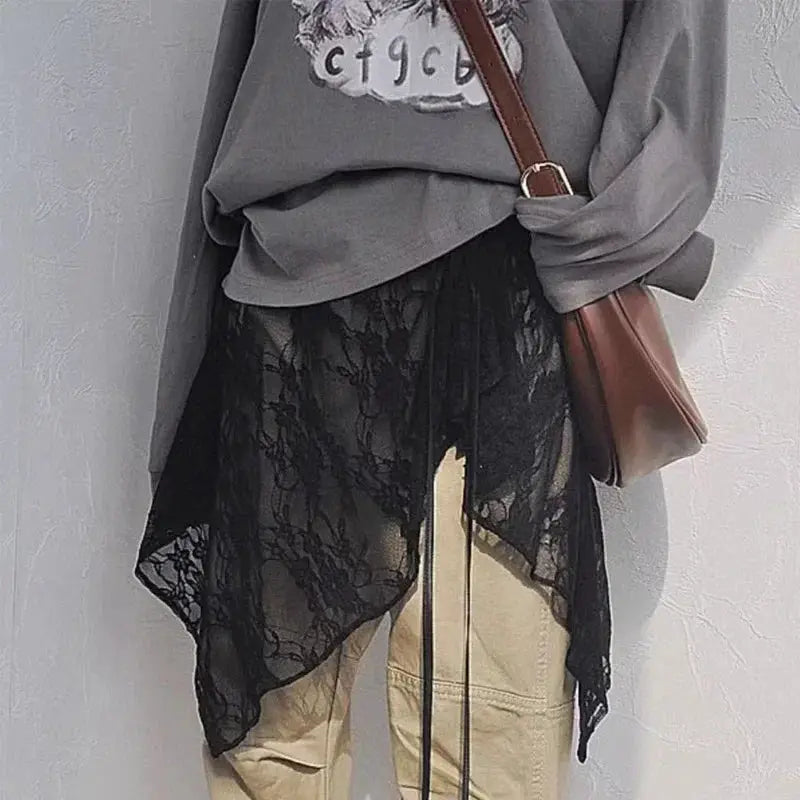 Lace wrap skirt by Simples Market; layered black lace over beige pants with a brown crossbody bag.