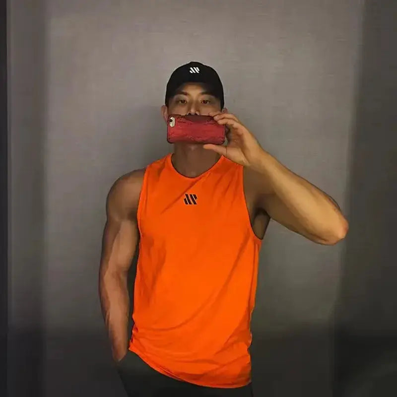 Men's orange stringer gym tank top with chest logo, fitness sleeveless shirt by Simples Market.