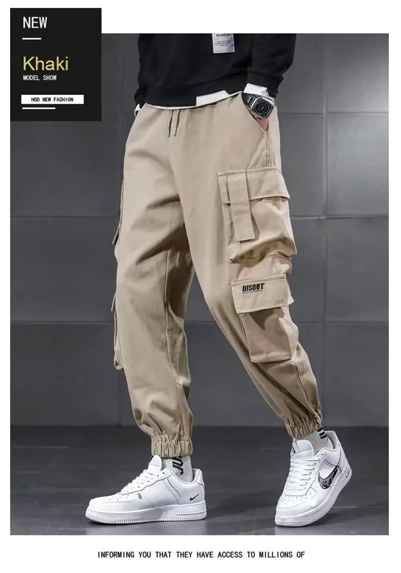 Khaki men's cargo pants with multiple pockets, drawstring waist, and elastic cuffs.