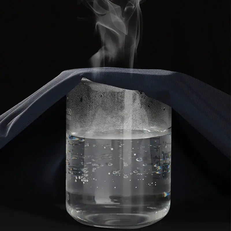 Jogging pants dark navy fabric draped over a steaming glass jar, studio shot