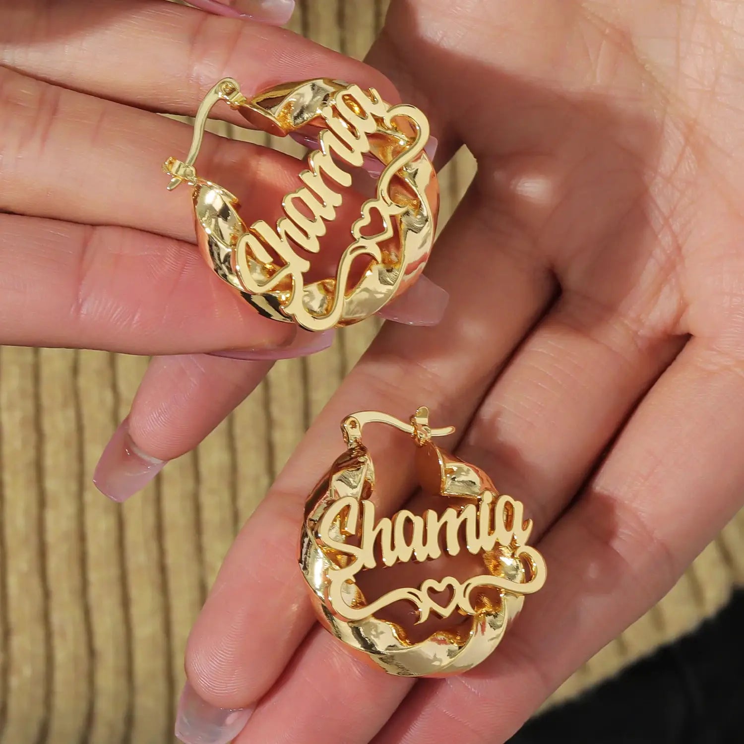 Gold-tone custom name hoop earrings, pair with twisted hoops and scripted name