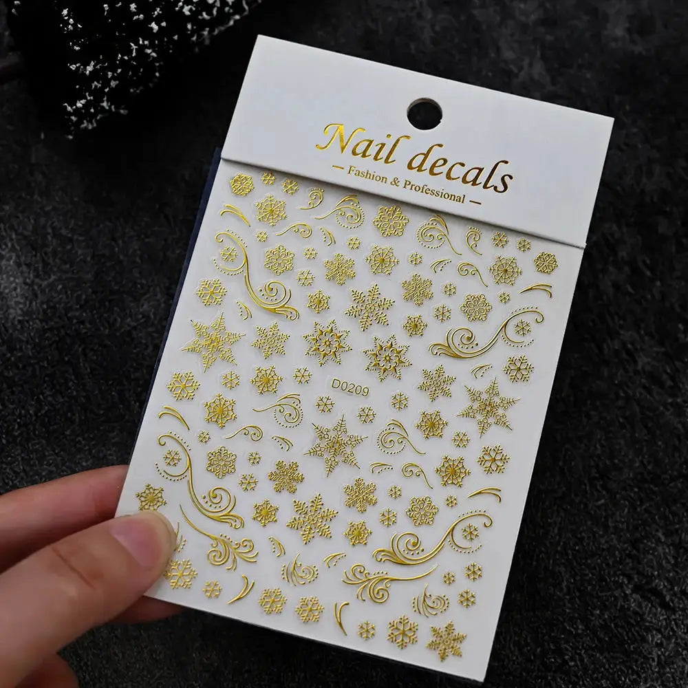 Gold winter nail decals sheet with snowflakes and swirls for festive nail art