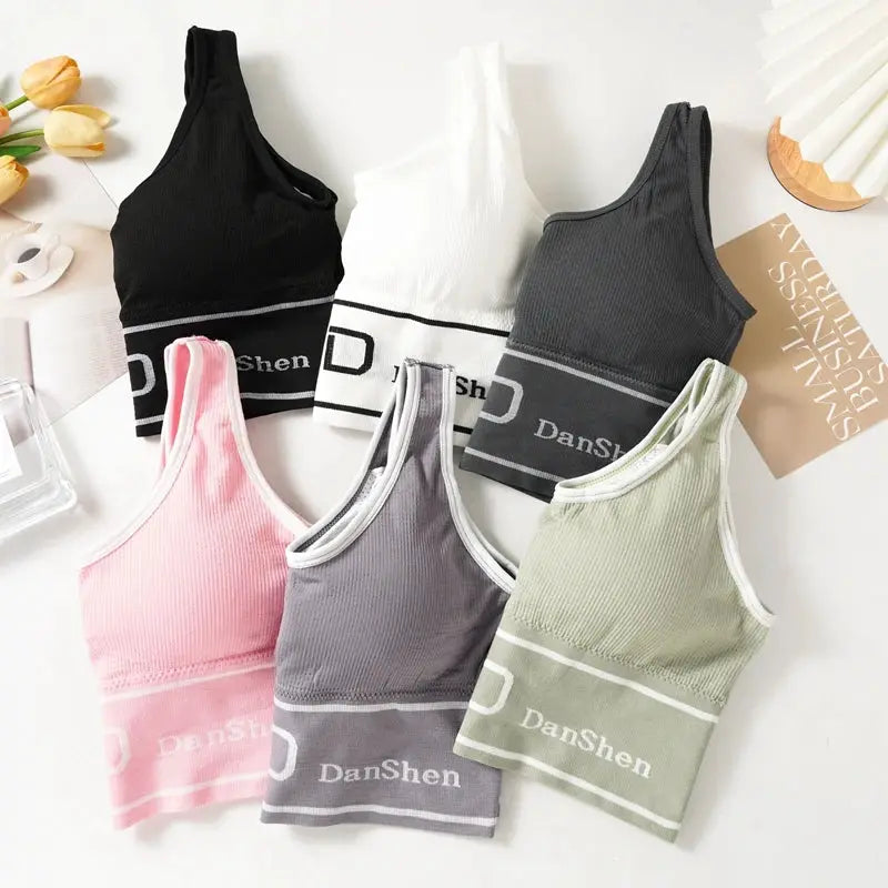Six DanShen seamless sports bras in full-coverage wireless design in black, white, gray, pink, lavender, and sage.