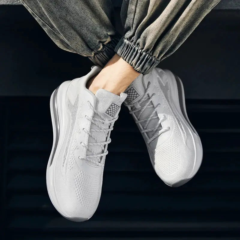 Men's white athletic sneakers with breathable mesh upper and grey laces