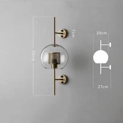 Modern glass wall lamp sconce with brass-finish vertical bar and clear glass globe.