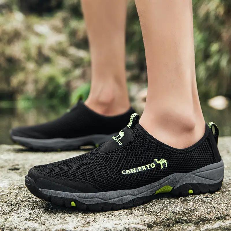 Pair of men's black mesh slip-on shoes with lime-green accents, breathable outdoor casual footwear.