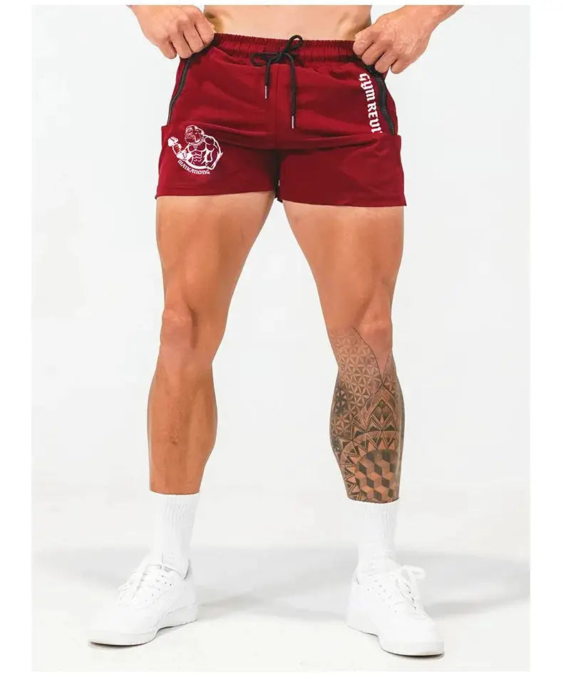 Men's red quick-dry gym shorts with side double zipper pockets, drawstring waist, white logo print on left leg.